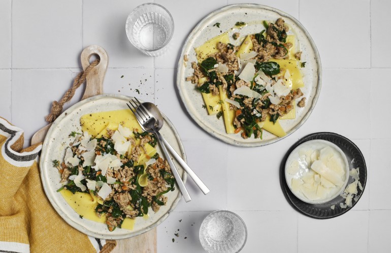 Two plates of Gluten-Free Blonde Bolognese on a stoneware plates ready to serve.